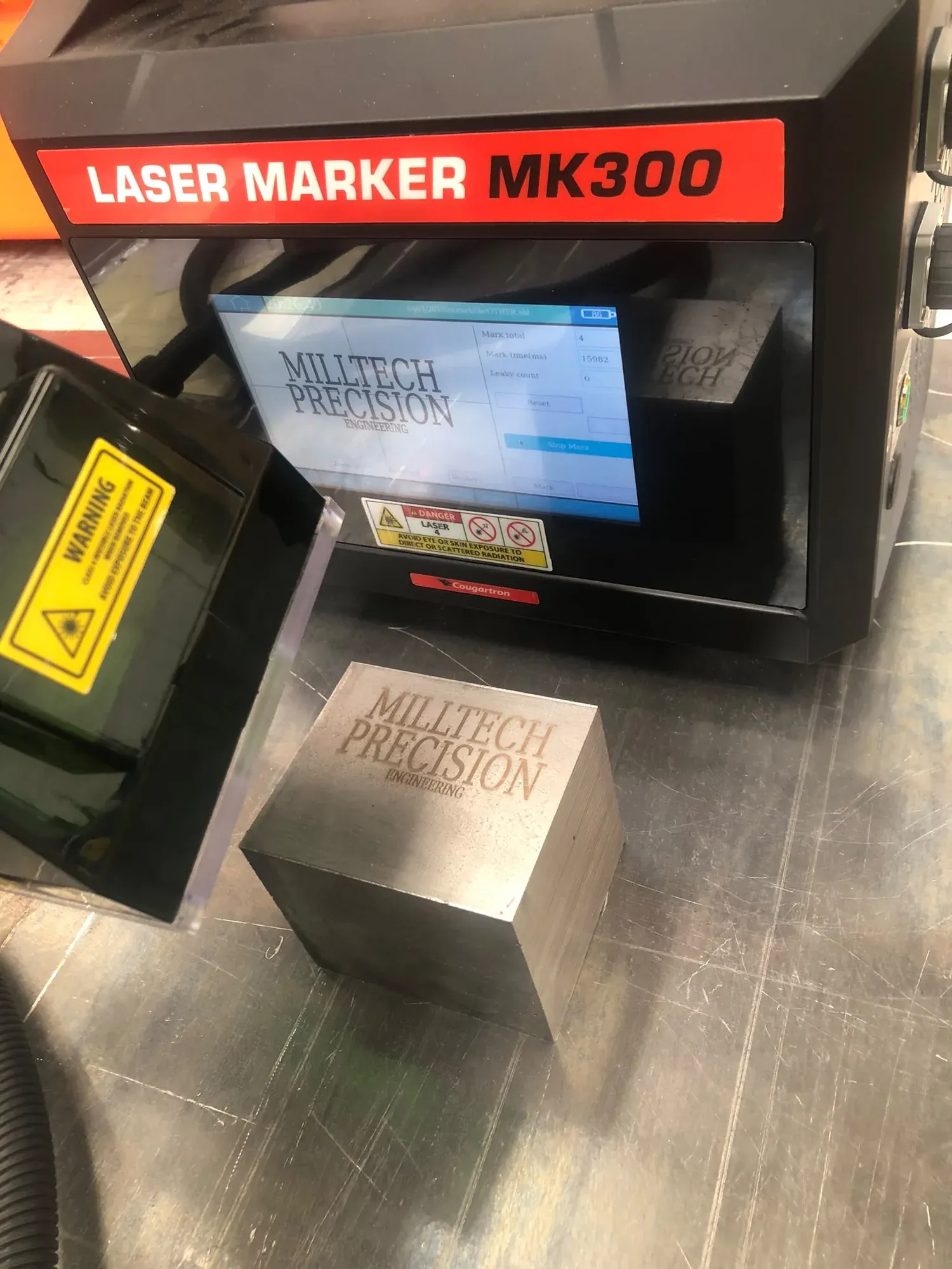 Milltech laser-marking a steel block with its material trace code